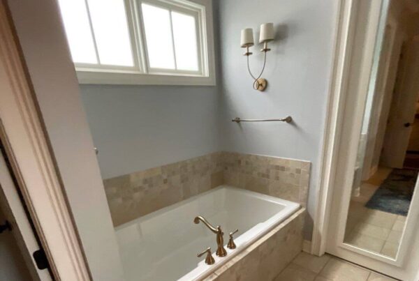 light blue bathroom renovation and bathtub by lewis roofing & construction
